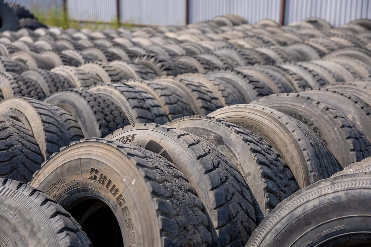 New commercial truck tires stacked in rows at a warehouse